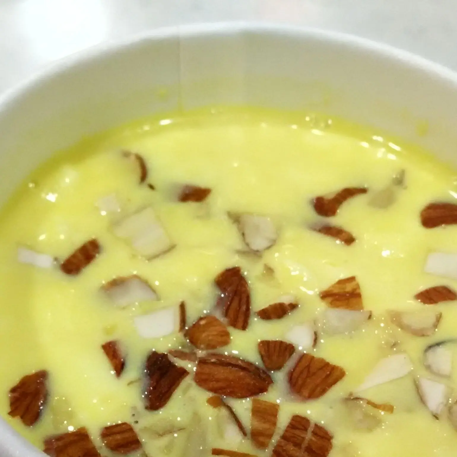 Badam milk topped with chopped almonds