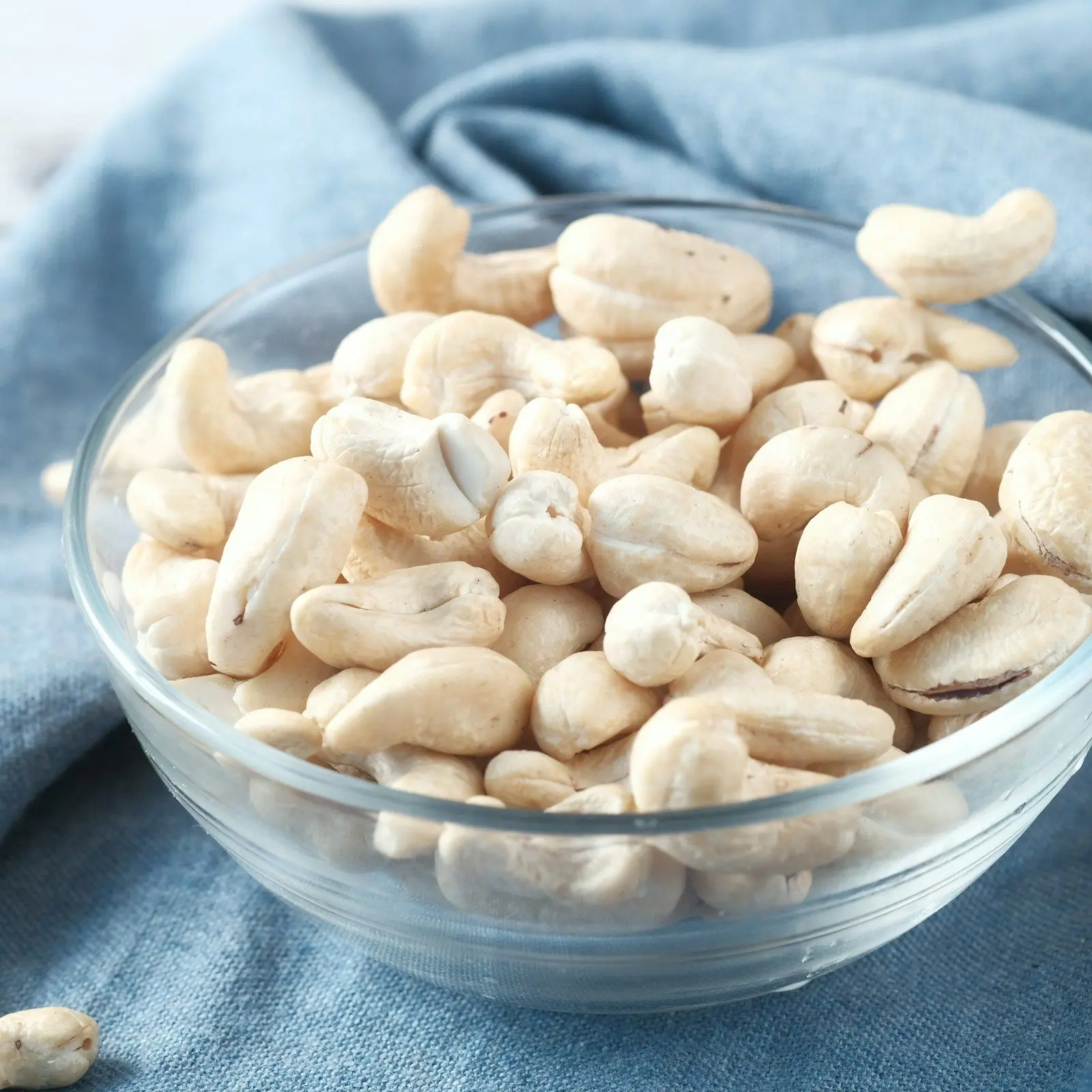 Large whole W240 cashew nuts in a glass bowl