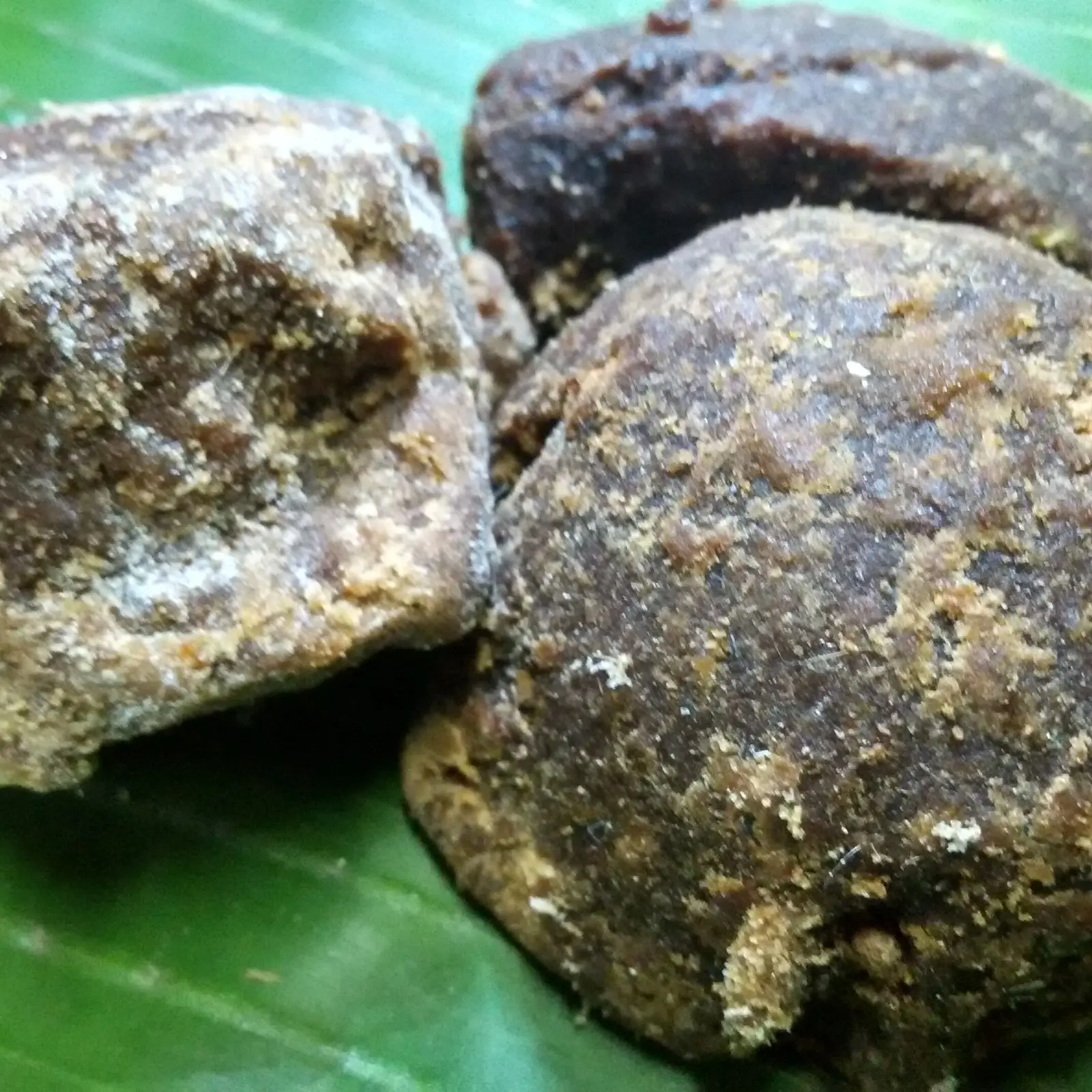 Palm jaggery (karupatti) pieces on a banana leaf
